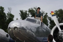 Amelia sitting atop Electra, talking to Fred.