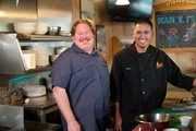 Host Casey Webb hangs with chef Ricky Baxa in the kitchen at Shanghai Red's.