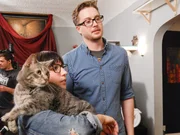 Cat owner Alison holding Pancake as she and Dylan look forward.