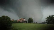 A tornado comes dangerously close to a house outside of Philadelphia, Mississippi.