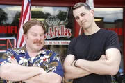 Host Casey Webb and his Bronx Bomber Challenge teammate Derek Jacobs pose for hero shots outside Roc-A-Fellas, as seen on Travel Channel's Man v. Food.