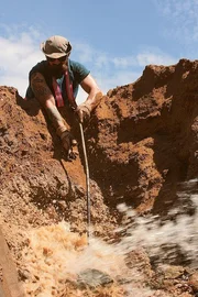 Fred Lewis, putting something in a ditch.
