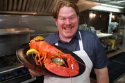 Man v. Food's Casey Webb poses with his stuffed lobster at Jersey Shore's Bahrs Landing.