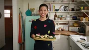 Portrait of Molly Yeh making her Pita and Greens Benedict with Feta Cream, as seen on Girl Meets Farm, season 7.