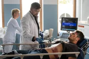 Marc Lindner (Christian Beermann, M. mit Komparsin, h.l.) untersucht seinen neuen Patienten Fred Wacker (Max Koch, r.). Der bei dem Versuch, seinen Kummer im Alkohol zu ertr&auml;nken, in der Notaufnahme gelandet ist.