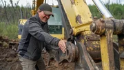 Andreas Macherey is trying to repair a broken excavator in the Yukon Territory, Canada. Andreas Macherey is trying to repair a broken excavator in the Yukon Territory, Canada.