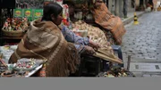 Ivet performs a protection ritual with coca leaves in front of her shop in La Paz, Bolivia, as seen in Travel Channel's Legendary Locations.