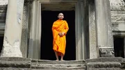 A monk stands in the temple of Angkor Wat, Cambodia, as seen on Travel Channel's Legendary Locations.