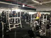 Crew filming Mariana van Zeller in a gym.