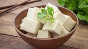 Tofu cubes in bowl and parsley