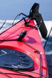 A red kayak on a wooden jetty / bridge deck.