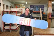 Checker Tobi alleine mit seinem selbst gebauten Snowboard.