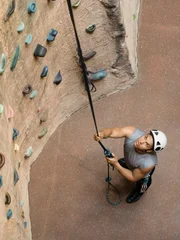 Man in Front of Climbing Wall