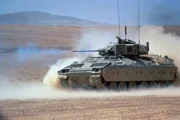 M-2 Bradley Infantry Fighting Vehicle fires its M-242 25mm Gun in the desert