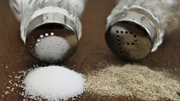 Salt and pepper on wooden table