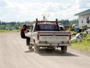 One of the cameramen (L) filming Charlie Wright as he drives through town. The crew always strives to film the best footage possible.