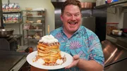 Host Casey Webb posed with The Pac Stack Challenge in Salt Lake City, UT as seen on Man v. Food, season 6.