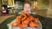 Host Casey Webb posed with the Atomic Ghost Wing Challenge at the Pizza Pit in Hudson Valley, NY as seen on Man v. Food, season 6.