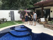 Portrait shot of contributors Rob and Patricia Martinez (right) with agent Rebecca Clower (left) in Guanacaste, Mexico, as seen on Rob and Patricia's house tour on House Hunters International (portrait)