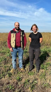 Jonas und seine ehemalige Auszubildende Luise stehen auf dem Feld.