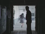 Reyna runs away from Elkins in a factory.