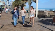 Bargain hunter Brittany (M) and two sisters Erica (R) and Lindsay (R) enjoy their ice cream while walking down Myrtle Beach's boardwalk, as seen on HGTV's original series, Beachfront Bargain Hunt.