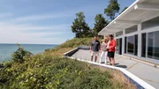 Real estate agent Ronda Busscher shows off the 75-feet of waterfront at the Cali Beach House to homebuyers Darren and Cindy, as seen on HGTV's Beach Hunters.