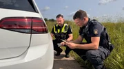 Officer Ricky Rausch and a colleague checking a tire