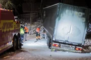 Overhalla, Norway - The truck that is stuck in the ditch and has problems on a slippery road is attached to a wire that is connected to the towing truck.   (photo credit: National Geographic)