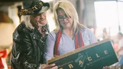 Sally and Laurence check over the box for a Mystifying Oracle board game that is up for bid during the Nashville auction.