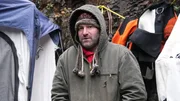 James Hamm in thick winter clothes in front of the dive tent