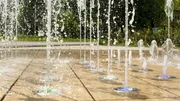 Many small splashing dancing fountains in summer Warsaw park Many small splashing dancing fountains in summer Warsaw park