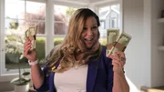 In her sit down interview, Lana M. poses with stacks of cash in both hands.