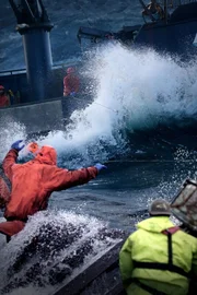 A few waves never scare the crew of Brenna A away from their duties.