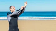 swimmer putting on his wetsuit swimmer putting on his wetsuit