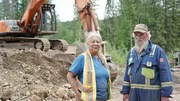 Jim Gibson & Wendy Tuerlings stood in front of an excavator