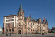 Wiesbaden, people at the market square with historic old town hall under blue sky.