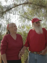 The builder talking with Santa Claus and Ms. Claus about building the treehouse.