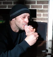 Robert Spahalski lighting a crack pipe (recreation).