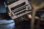 Odda, Norway - Truck attached to one wire and a strap. The truck is getting help up from the ditch.   (National Geographic)