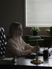 Vicki Sexton is sitting at her desk.