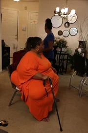 Chitoka taking a break from walking in her house. Chitoka taking a break from walking in her house.