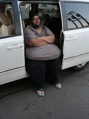 Dominic sits in side of van