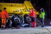 Overhalla, Norway - Snow plow tipped over. Roger Heggli attaching a wire to the plow.