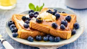 French toast flavored with blueberries, butter, mint and drizzled with maple syrup.