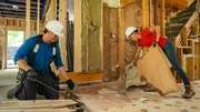 Michael (left) and Sherry Holmes (right) peel up some old linoleum flooring in this kitchen as seen on HGTV's Holmes Family Rescue Season 2