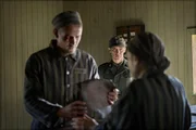 Jonah Hauer-King as Lali Sokolov & Jonas Nay as Nazi Officer Stefan Baretzki in Auschwitz.