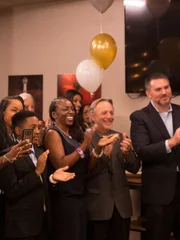 The crowd cheers and claps at the reveal party. The crowd cheers and claps at the reveal party.