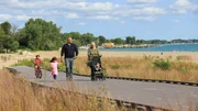 Busy parents Prashant and Marci enjoy an afternoon stroll on the lake with their three young kids, as seen on HGTV's Beach Hunters.