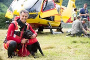 Rescue dogs with their owner by a helicopter in Italy. Rescue dogs with their owner by a helicopter in Italy.